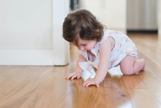 Crawling baby exploring a bright living room floor