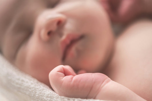 Sleeping newborn baby wrapped in a soft blanket