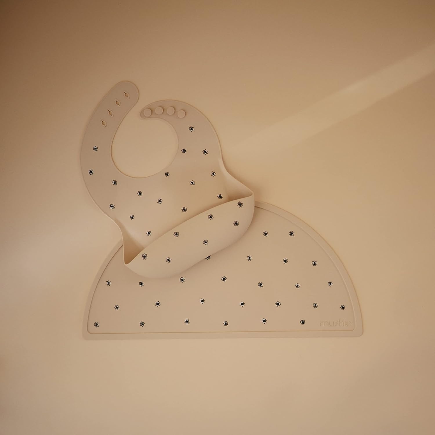 mushie Silicone Baby Bib | Adjustable Fit Waterproof Bibs (Black Daisy)