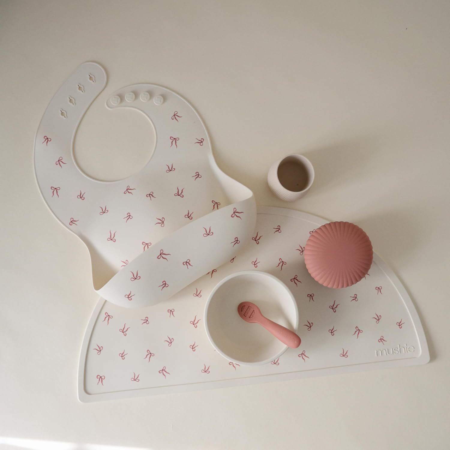 mushie Silicone Baby Bib | Adjustable Fit Waterproof Bibs (Bows)
