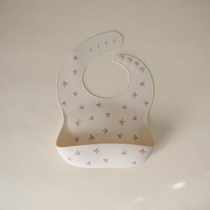 mushie Silicone Baby Bib | Adjustable Fit Waterproof Bibs (Bows)