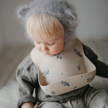 mushie Silicone Baby Bib | Adjustable Fit Waterproof Bibs (Lilac Flowers)